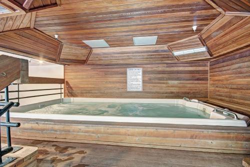 a large jacuzzi tub in a room with wooden walls at VS553 Village Square Hotel Room Hotel Room in Wheeler Junction