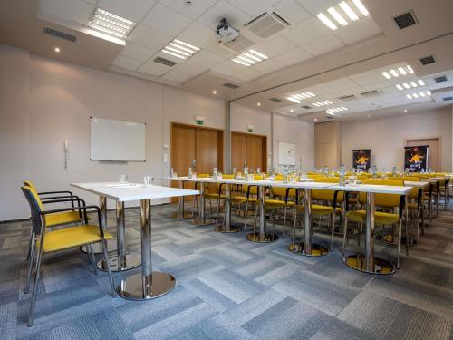a classroom with tables and chairs in a room at Ibis Hotel Plzeň in Plzeň