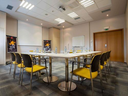 a conference room with a large table and chairs at Ibis Hotel Plzeň in Plzeň