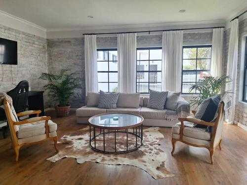 a living room with a couch and a coffee table at Foam House in Bloubergstrand