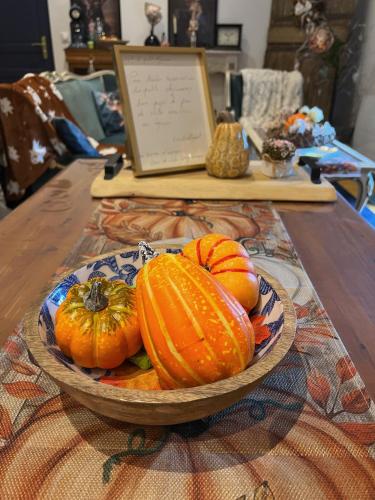 a bowl of pumpkins sitting on a table at Au petit bonheur de séraphine in Saint-Aubin