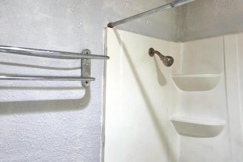 a bathroom with a white toilet and a sink at Deluxe Inn Motel By OYO Grand Prairie Interstate 30 in Grand Prairie