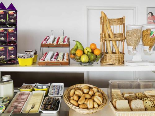 a shelf filled with lots of different types of food at ibis Budget Luxembourg Sud in Livange