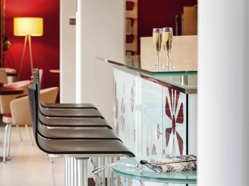 a bar with two glasses on top of a counter at Ibis Lugano Paradiso in Lugano