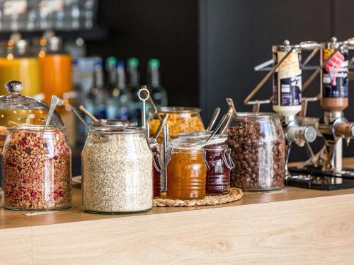 a group of jars of food on a counter at Ibis Lugano Paradiso in Lugano