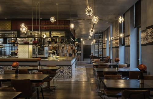 a restaurant with tables and chairs and a bar at The Posthouse Berlin Potsdamer Platz- Leonardo Limited Edition in Berlin