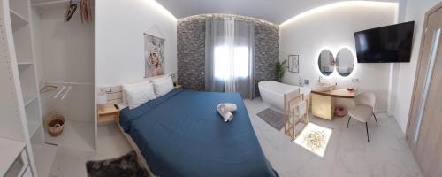 a bedroom with a blue bed in a room at My Hersonissos Home Brand New Luxury apt in Limín Khersonísou