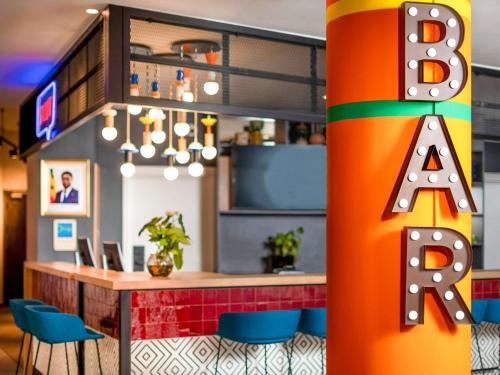 an office with a bar with blue chairs at Ibis Styles Dakar in Dakar