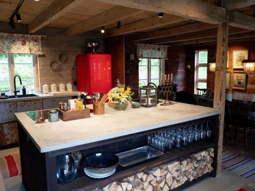 a kitchen with a counter and a red refrigerator at Cozy house in the countryside in Torestorp