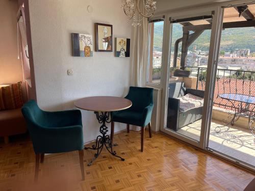 a room with a table and chairs and a balcony at Villa Stefanija in Ohrid