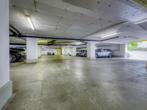 an empty parking garage with cars parked in it at ibis budget Hotel Luzern City in Luzern