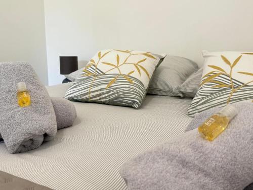 a bed with two pillows and a couch with two at Gite Pont de Crillon in Crillon-le-Brave