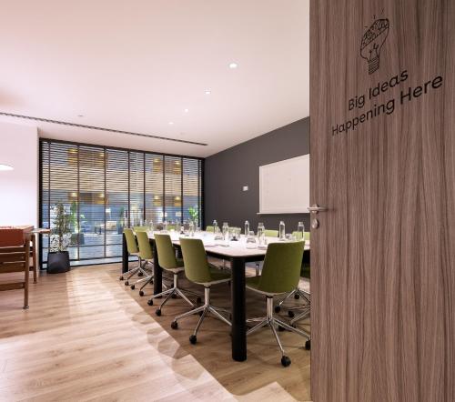 a conference room with a long table and chairs at INNSiDE by Meliá Barcelona Aeropuerto in El Prat de Llobregat