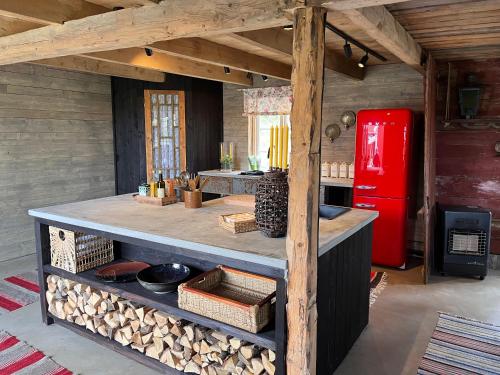a kitchen with a counter and a red refrigerator at Cozy house in the countryside in Torestorp