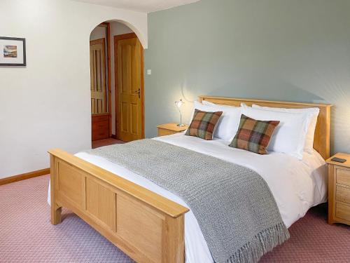 a bedroom with a large white bed with two pillows at Innish - Uk38783 in Clachan