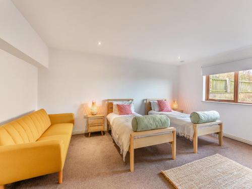 a living room with two beds and a couch at The Beaches in Berwick-Upon-Tweed