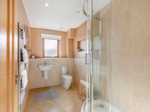 a bathroom with a shower and a toilet and a sink at The Beaches in Berwick-Upon-Tweed