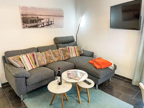 a living room with a couch and a table at Apartment Müritz Ferienpark Röbel-32 by Interhome in Marienfelde