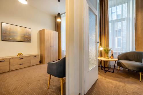 a living room with a chair and a table at Hotel Lothus in Wrocław