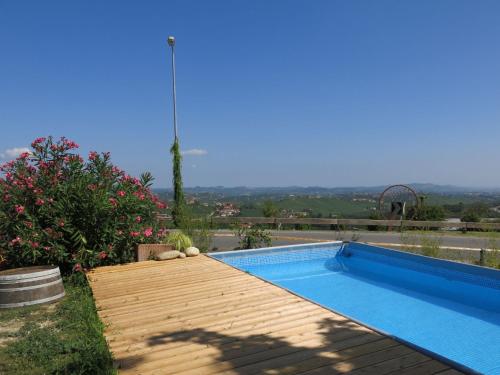 a swimming pool in a garden with a view at Apartment Il Sole by Interhome in La Morra