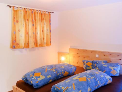 a bedroom with two beds with blue sheets and a window at Apartment Berganger by Interhome in Bernau