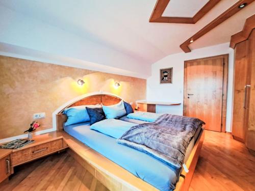 a bedroom with a large bed with a wooden headboard at Apartment Berganger by Interhome in Bernau