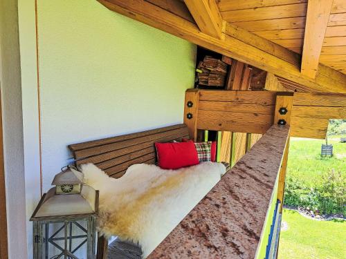 a bed in a room with a wooden ceiling at Apartment Berganger by Interhome in Bernau