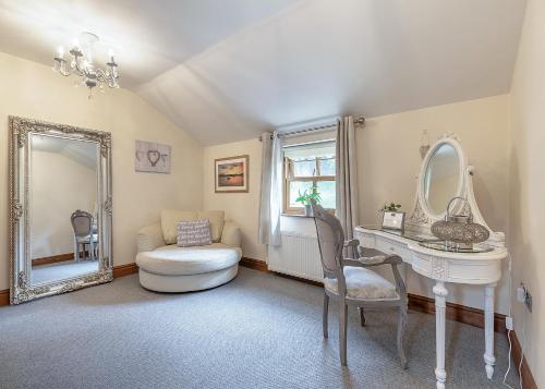 a bathroom with a white vanity and a mirror at Charlesworth Lodges in Glossop