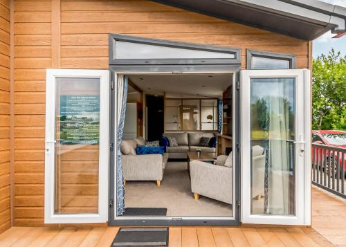 an open sliding glass door on a house at Hanworth Country Park in Potter Hanworth