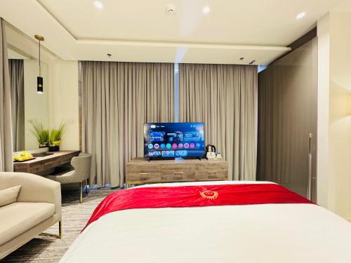 a hotel room with a bed and a television at TAJ Executive Hotel F7 Islamabad in Islamabad