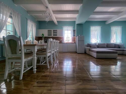 a living room with a table and a couch at Napsugaras Birtok in Röszke