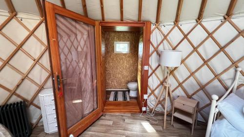a room with a toilet in a yurt at Rock Farm Slane - Glamping in Slane