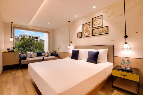 a bedroom with a large white bed and a window at Keys Lite by Lemon Tree Hotels, Jaipur in Jaipur