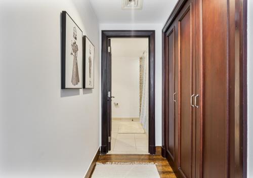 a hallway with a door leading to a bathroom at 2BR Downtown Dubai 5 Min Walk to Dubai Mall & Burj in Dubai