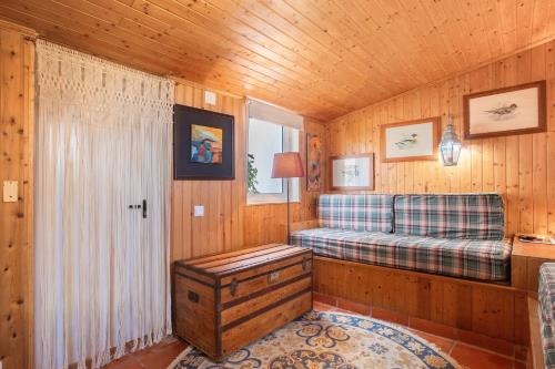 a room with a couch and a window in a cabin at Casa do Campo Dornes Dois in Paio Mendes