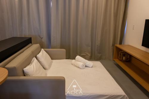 a hotel room with a bed with two pillows on it at Villa Naluri - Seu Refúgio a 50 metros da praia em Japaratinga in Japaratinga