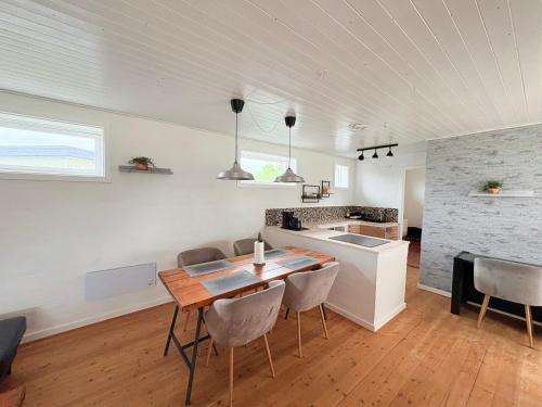 a kitchen and dining room with a table and chairs at Lejlighed Edelweiss in Svendborg