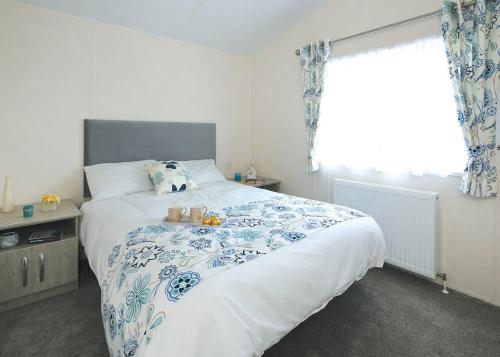 a bedroom with a large bed and a window at Springhouse Country Park in Slaley