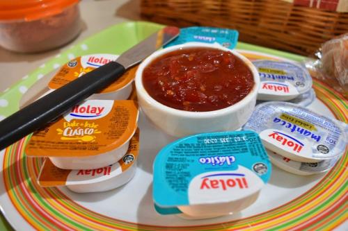 a plate of food with jam and a bowl of sauce at Apart Piedra Libre in Tandil