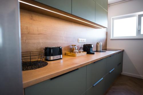 a kitchen with a counter with two microwaves on it at Sky9 Apartment in Odorheiu Secuiesc