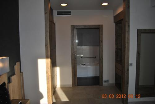 a hallway with a door to a room with a television at Santa Bárbara in Sant Corneli de Cercs 