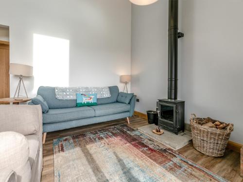 a living room with a couch and a fire place at Shutlingsloe in Mellor