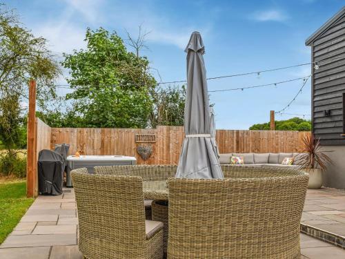 an umbrella sitting on a table in a backyard at Dodds Barn in Fersfield