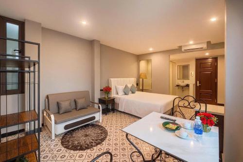 a hotel room with a bed and a chair at Hanoi Old Town in Hanoi