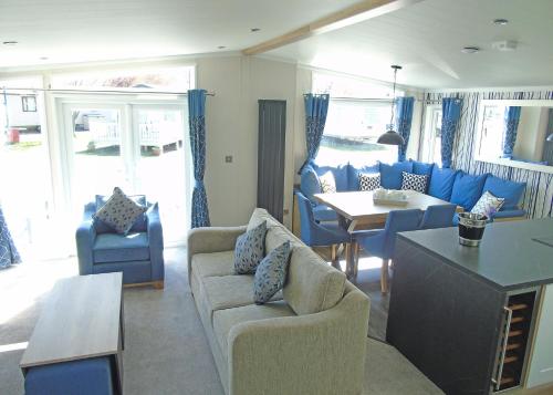 a living room with a couch and chairs and a table at Fir Trees in Chester