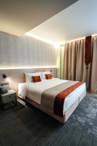 a hotel room with a large bed and a window at Yourta in Oral