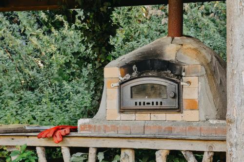 a stone oven sitting on top of a fence at Rock Farm Slane - Glamping in Slane