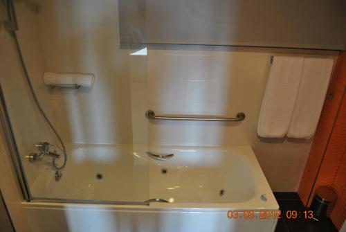 a bathroom with a shower and a toilet and towels at Santa Bárbara in Sant Corneli de Cercs 