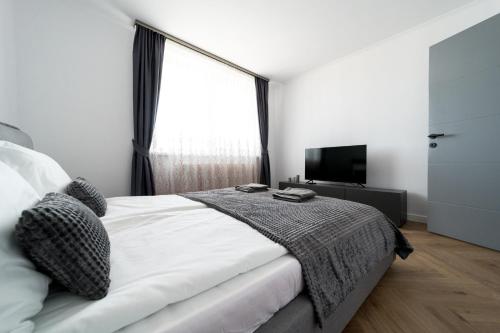a bedroom with a bed and a large window at Sky9 Apartment in Odorheiu Secuiesc