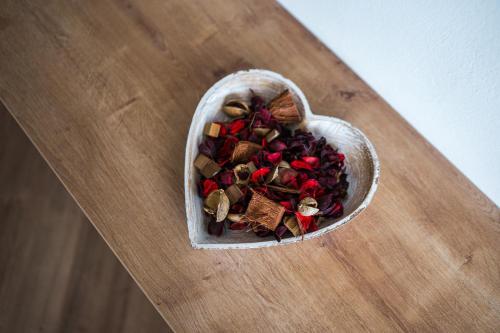 a bowl of food sitting on a wooden table at Sky9 Apartment in Odorheiu Secuiesc